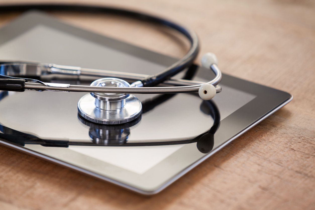 Close-up of stethoscope on digital tablet  in clinic